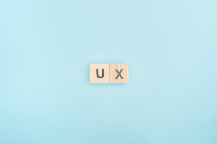 ux lettering made of wooden cubes on blue background